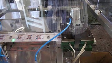 Playing card over wrapping machine