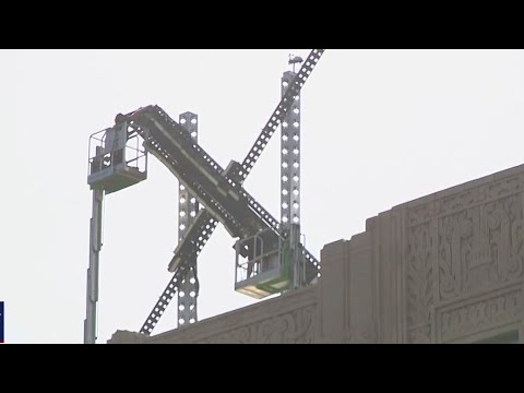 Crews take down X on former Twitter building