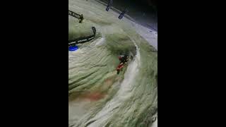 Guy riding snowmobile makes a sharp turn and lands underneath the snowmobile during race