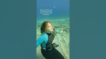 female freediver underwater with no mask on and no fins