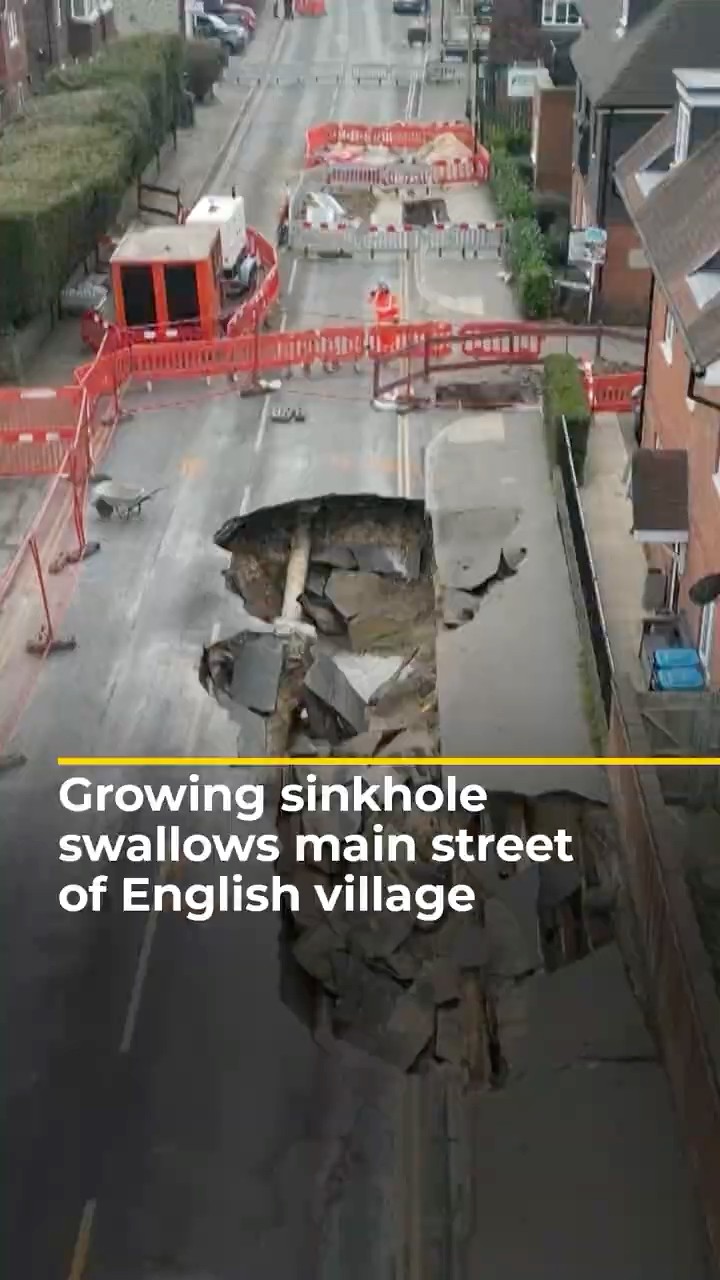 Growing sinkhole swallows main street of English village