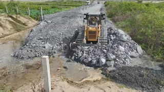 Nice Action Building Road on Forest Lake By KOMATSU Bulldozer D60P Pushing Rock With Truck