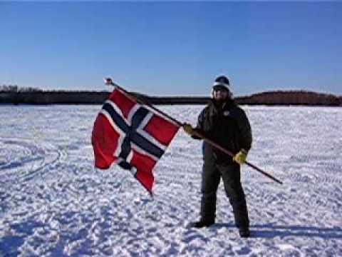 Sons of Norway member, Clifton Chandler, waves the Norwegian flag for mushers Robert Sorlie and Sigrid Ekran from Norway at the Re-start of Iditarod 2007 on March 4, 2007 in Willow, Alaska! Video by Julie Sanders Keymer