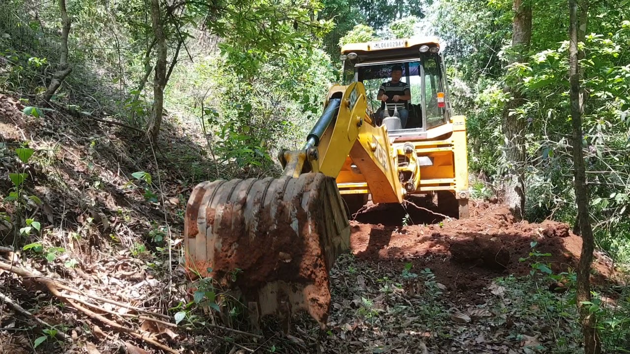jcb Constructing new road in the jungle