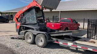 Kubota SVL752 loading up on a Diamond C HDT 207 Gooseneck Tilt Deck Trailer