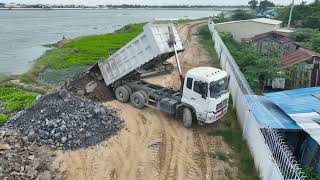 Entire project Big Lake is being filled with stone! Bulldozer pushing stone, transporting by truck