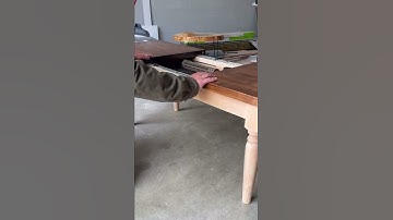 Hidden compartment coffee table holds full size AR secured with fingerprint scanner.