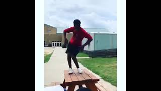 Man listening to trap music, dancing falls of the picnic table at the high school