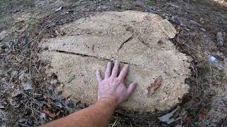 Pushing brush and yard waste over the hill with Backhoe