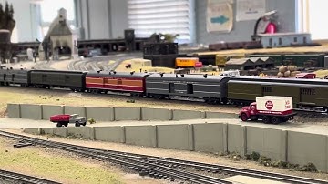 Brass AC-5 cab forward with tsunami sound pulling mail train. Look for the two power cars
