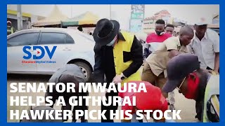 Senator Mwaura helps a Githurai hawker pick his stock that was knocked down by a motorcycle