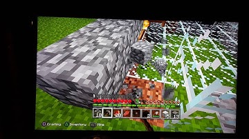Nephew is adding finishing touches on glass house  on Minecraft