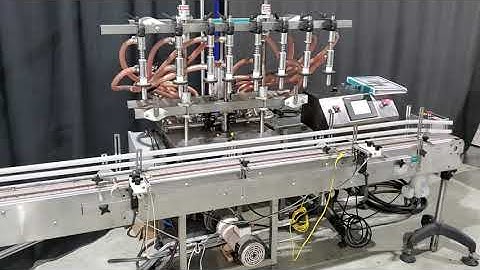 Inline Filling Systems 8 head overflow filler model FOFHP-416 with conveyor, gaiting and buffer tank