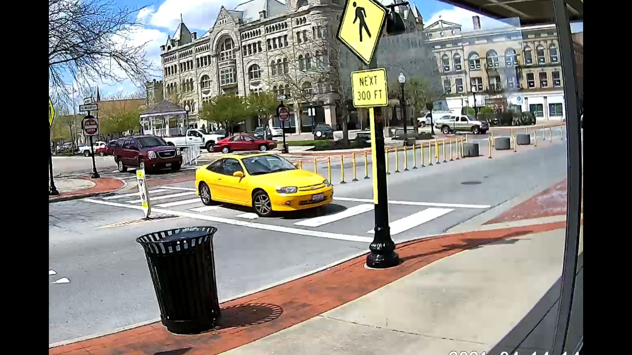 Yellow car uses crosswalk