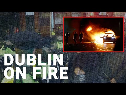 Dublin stabbing: anti-immigration protesters clash with riot police, set bus ablaze