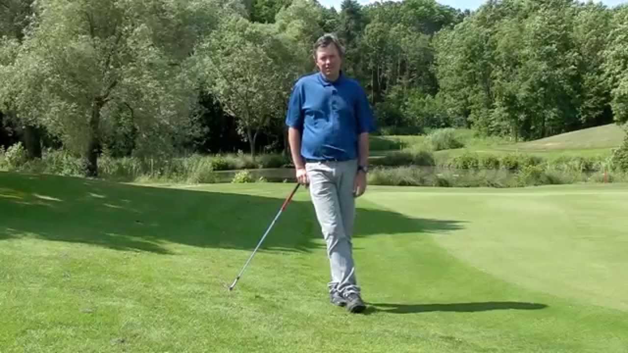 How to hit a downhill chip shot from a bad lie video short game tip YouTube