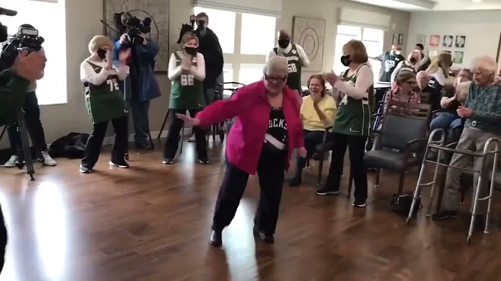 Judy Brannon dances with the Milwaukee Bucks Grand...