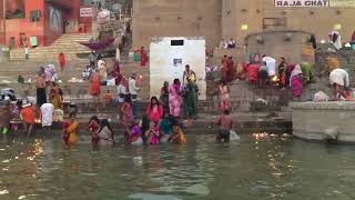 India Varanasi. People Bathing In Religious Ritual In The Highly Polluted Ganges River