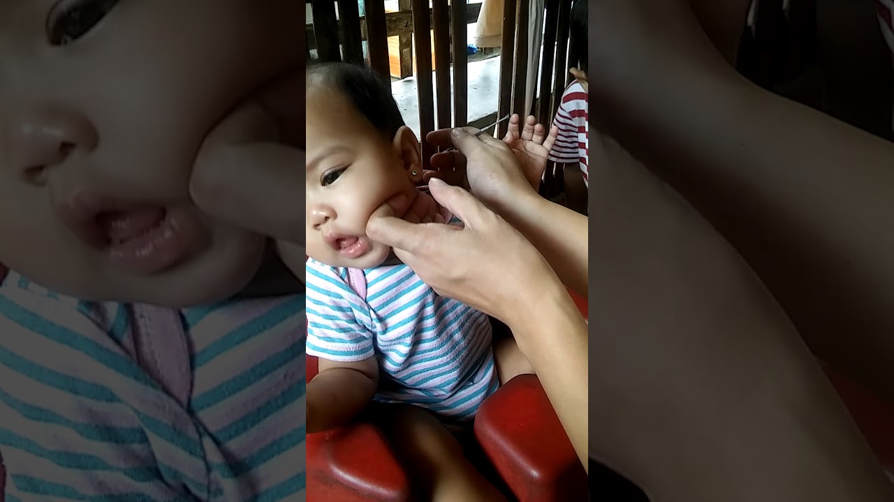 Cute little baby getting sleepy when her mom clean up her ears. - YouTube
