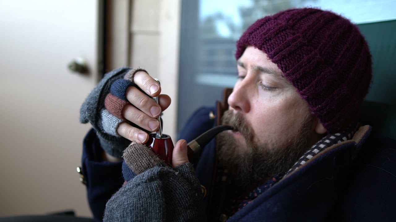A man relaxes and smokes Early Morning Pipe tobacco early in the morning