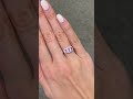 Stunning pink sapphire trilogy engagement ring in a diamond halo