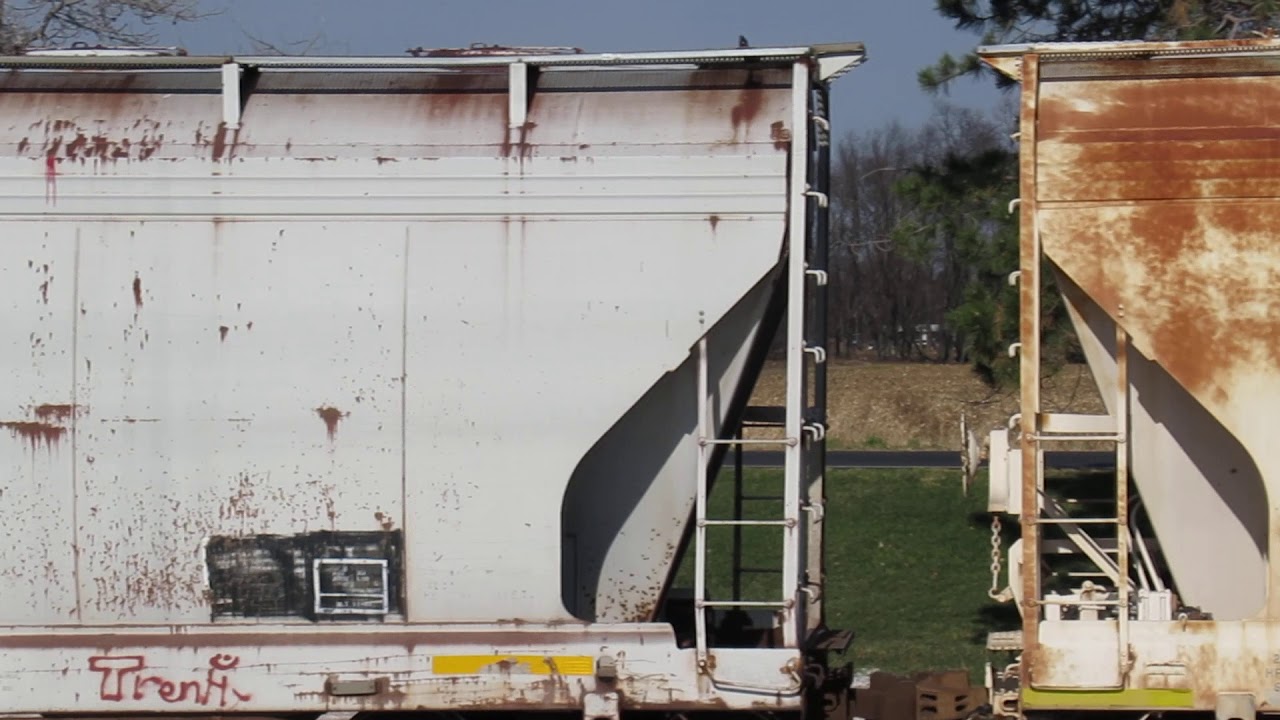 Zoomed in view of 2 American Car & Foundry CENTER FLOW covered hoppers on Harborlite spur track