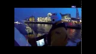 Tower lifeboat crew rescue man clinging to rubbish catcher in River Thames