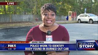 Police work to identify body found in burned out car