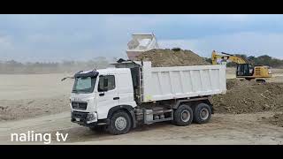 Wowww white colors dumptruck nice looking while dumping at the site. Philippines