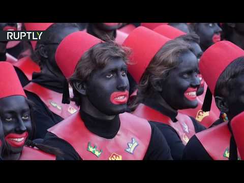 Spanish teenagers don blackface and hand out gifts to children in parade