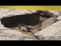 Crumbling road closed after water main break in Forest Hills