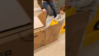 Little boy rides Hot Wheels car on track into box and bumps his head
