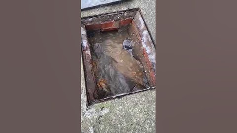 How to unblock a manhole with a stick. Blocked manhole chamber