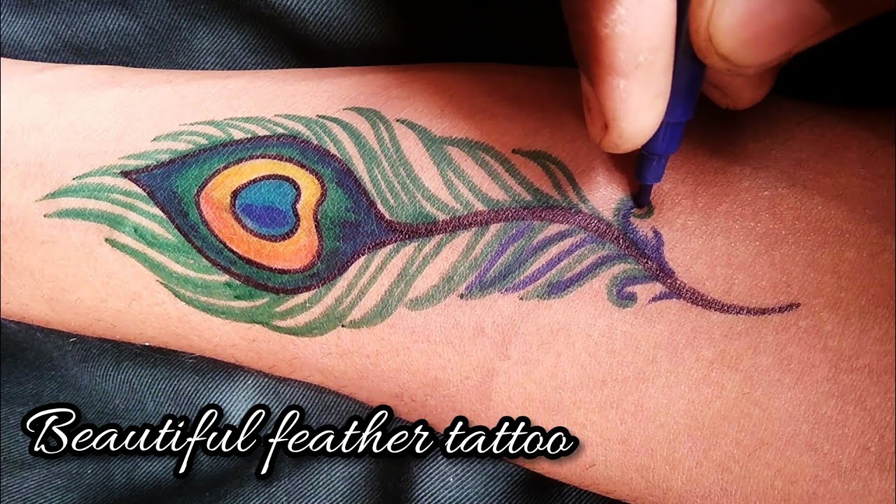 Tattoo uploaded by Rtattoo studio  Peacock feather tattoo Bansuri tattoo  colourful feather tattoo peacock feather tattoo Bansuri tattoo  Krishna bansuri tattoo Krishna feather tattoo beautiful tattoo feather  tattoo  Tattoodo