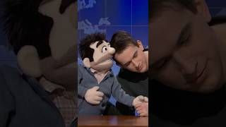 andrew and his puppet father perform their routine at the desk