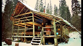 Hike in the woods to a 2-story log cabin