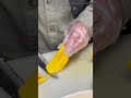 slicing ripe yellow mango on a wooden board