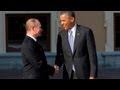 Obama and putin greet with long handshake