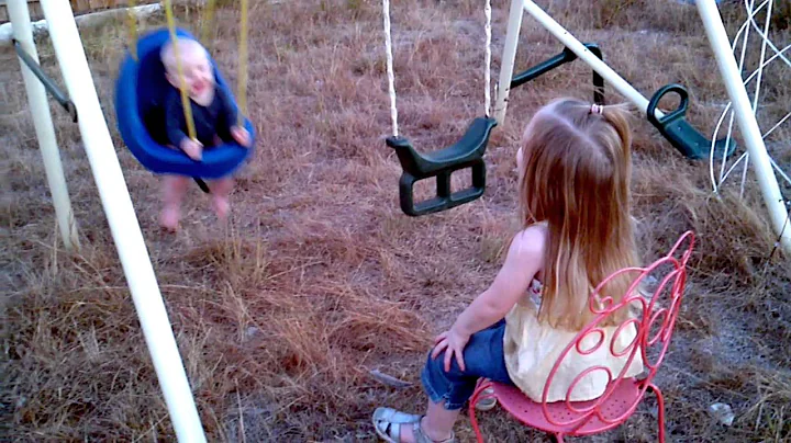 Valerie pushing Adler in the swing