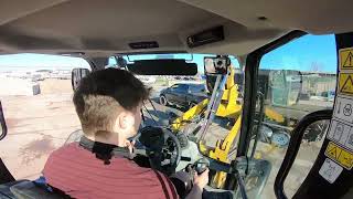 Caterpillar 908M Hard at work on a Busy Morning! - Cab POV