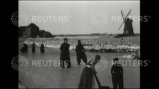 1929 THE NETHERLANDS / LAND YACHTING: Land yachts on ice and residents of Volendam skating