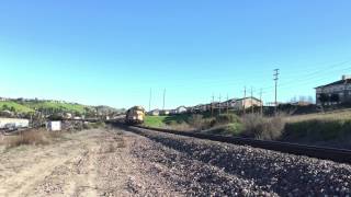 Two BNSF engines in old Sante Fe livery pulling empty intermodal cars