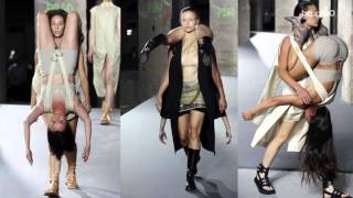 Models walk the runway carrying other models in bizarre Rick Owens show