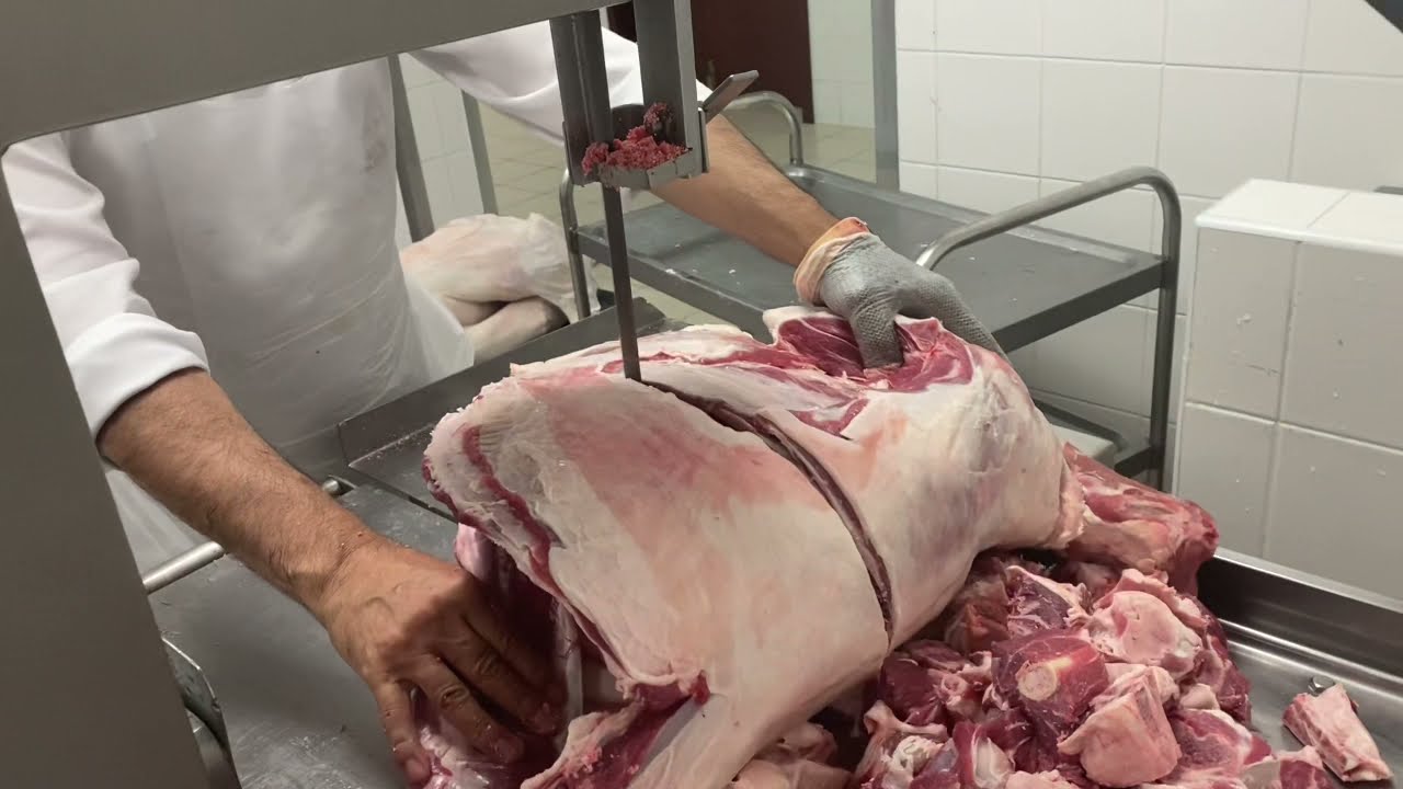 Super faster butcher cutting Meat by bandsaw machine. 