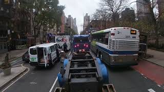 Large excavator transported through Manhattan. Cat 335 navigating traffic on a lowboy