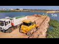 Next level mighty bulldozer shantui the powerful is working push soil in water to build roads added