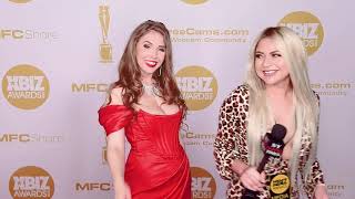 Curvaceous Lena Paul in a stunning fitted bright red dress on the 2020 Xbiz Awards red carpet