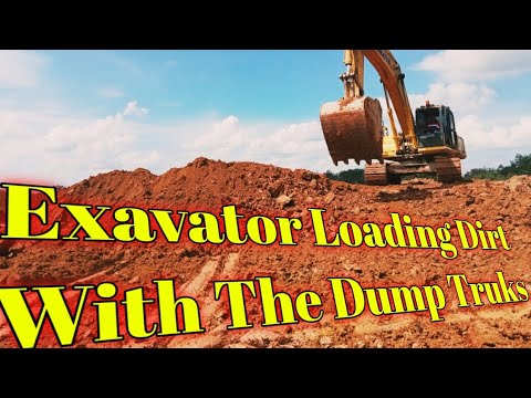 Komatsu PC200 Exavator Loading Dirt With The Dump Truks