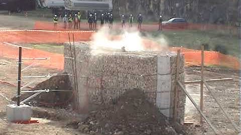 Rockfall impact on a protective embankment