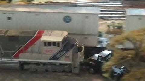 N scale train hits truck stuck on tracks
